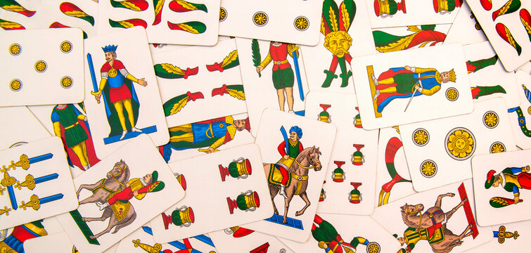 Spanish-suited playing cards. The Neapolitan pattern widely used in central and southern Italy. Zenith view on bulk playing cards. Ideal for background or backdrop. Card games.