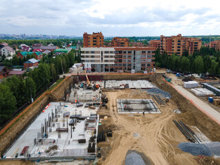 Fototapeta premium the construction site of an apartment building in the summer from a height