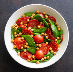 Salad with spinach, sausage, tomatoes and chickpeas. Healthy eating. Diet.