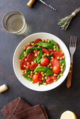 Salad with spinach, sausage, tomatoes and chickpeas. Healthy eating. Diet.