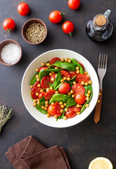 Salad with spinach, sausage, tomatoes and chickpeas. Healthy eating. Diet.