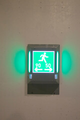 green light shows the way to the emergency exit when driving in the tunnel in Germany