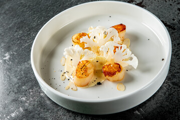 fried Scallop seafood appetizer with spices on plate