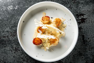 fried Scallop seafood appetizer with spices on plate