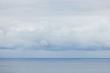 Naklejka na ściany i meble Cloudy over the sea at bad weather