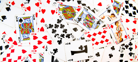 Card games. Zenithal view on French-suited decks. Background and backdrop with poker cards for casino and gambling games. Ideal for texture and pattern.