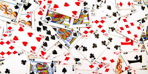 Card games. Zenithal view on French-suited decks. Background and backdrop with poker cards for casino and gambling games. Ideal for texture and pattern.