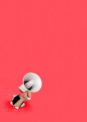 Loudhailer, hand holding megaphone breakthrough paper hole. Announcement, advertising, public hearing concept. Mockup design with loudspeaker, Torn background with blank empty space for copy space