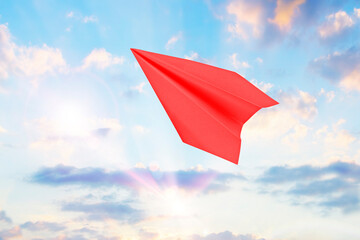Red paper plane in the sky. Concept of dream, goal achievement, freedom, travel, education,...