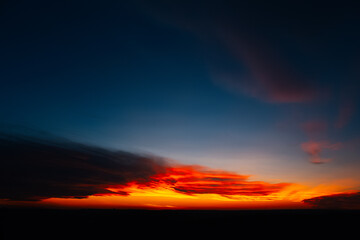 Beautiful landscape of colourful dark sunset or sunrise.