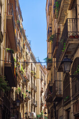 Traditional Barcelona Historic Center buildings with iron balconies and road lanterns in Catalonia Spain.