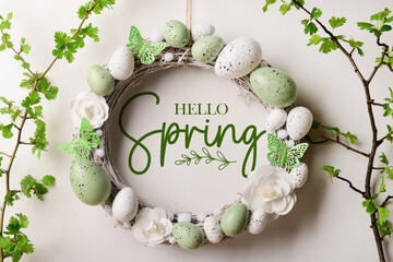 Banner with text HELLO SPRING and Easter wreath