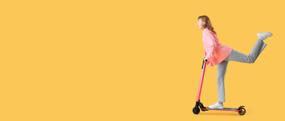 Portrait of panicked businesswoman riding kick scooter on yellow background with space for text
