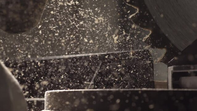 4K Highspeed video of an electric circulating saw cutting thru wood