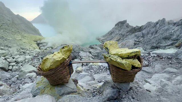 Baskets of sulpfur extracted from crater of Kawah Ijen volcano, Java, Indonesia
