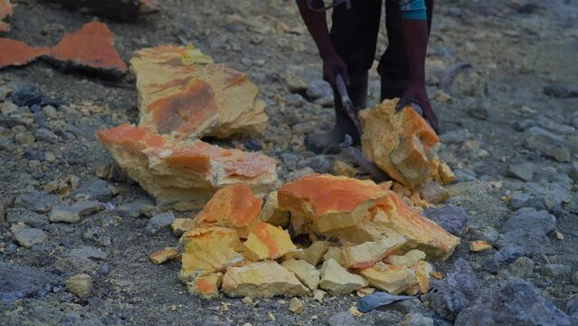 Close-up shot of sulfur being extracted from Kawah Ijen volcano, Java, Indonesia