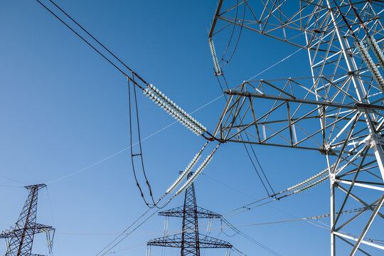 High voltage substation.World electricity crisis.Steel power transmission pylons