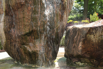 two large rocks rock structure waterfall fountain with water coming down from the top with bottom...
