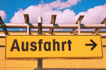 German road sign. Exit sign with an arrow pointing to the right in a supermarket. A yellow sign...