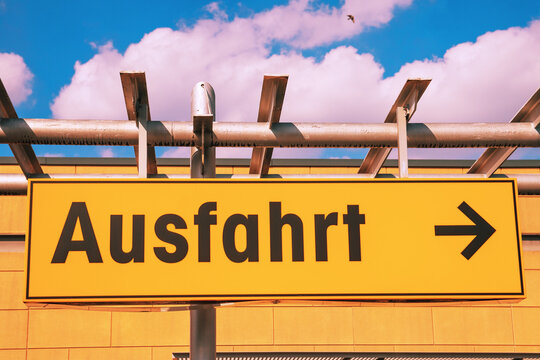 German road sign. Exit sign with an arrow pointing to the right in a supermarket. A yellow sign with the German word Ausfahrt.