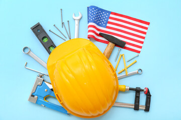 Hardhat with different tools and USA flag on blue background. Labor Day celebration