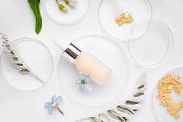 Petri dishes with sample, herbs and bottle of cosmetic product on white background