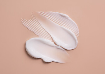 Cosmetic smear of cream texture on a beige background. Skin care.