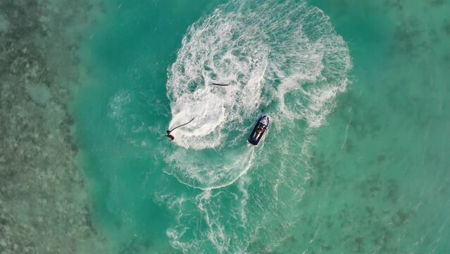 Fly Board and Jet ski in turquois water in the Maldives. Aerial Drone Video