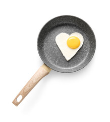 Frying pan with tasty fried egg in shape of heart on white background