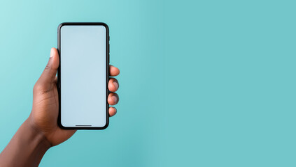 A human hand holding a smartphone, cell phone, mobile phone on a blue, green background. Mock-up concept. Copy space for text, advertising, message, logo