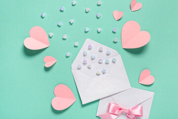 Composition with envelopes, paper hearts and glass stones on color background. Valentine's Day...