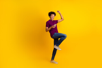 Fototapeta na wymiar Full length photo of crazy funky man wear stylish outfit raised hand fist shout yes hooray win jackpot isolated on yellow color background