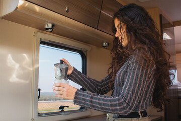 girl drinking coffee in her motorhome.