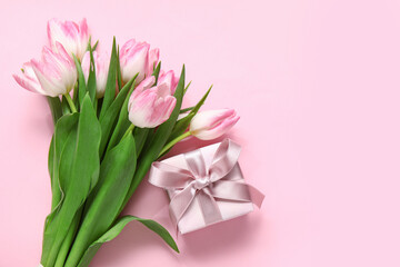 Gift box with tulips on pink background
