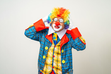 Mr Clown. Portrait of sadness face Clown man in colorful uniform standing crying feeling sad emotional. Expression male bozo in various pose on isolated background.