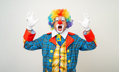 Mr Clown. Portrait of angry psycho mad comedian face Clown man in colorful uniform wearing wig...
