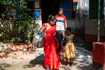 South asian hindu religious rural couple leaving home for a family trip with their  daughter 