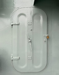 Metal door with padlock from a ship. Watertight boat door. Isolated vintage vessel door.