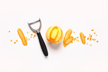 Composition with fresh ripe orange and peeler on white background