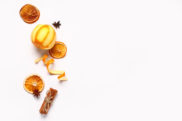 Composition with orange and spices on white background