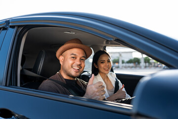 Young asian couple man and woman travel by car on a bright day beautiful blue sky sunlight. They...