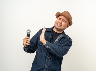 Naklejka premium Scary microphone hate boring to speak Sadness and stress young asian man nervous singing song. Artist vocalist singer on isolated background. Man public speaking talking afraid of public speech