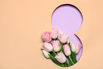 Cut beige paper in shape of figure 8 with beautiful tulip flowers on purple background. International Women's Day