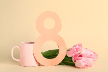 Paper figure 8 with tulip flowers and cup of coffee on beige background. International Women's Day celebration