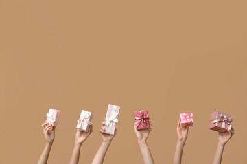 Women with gifts on brown background. Mother's Day celebration