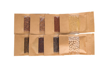Various types of seeds in paper bags isolated on a white background.