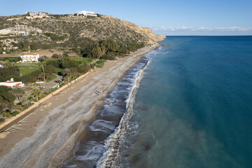 Obraz premium Aerial drone scenery of coastline. People walking in the beach . Stormy waves in winter
