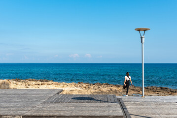 Unrecognized woman exercising at the beach. Healthy lifestyle