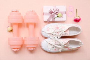 Composition with dumbbells, shoes and gift for International Women's Day on color background