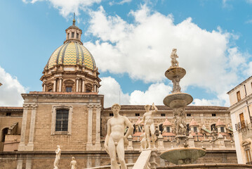 Fototapeta premium The Praetorian fountain with the dome of San Giuseppe dei Teatini church in the background, Palermo, Sicily, Italy